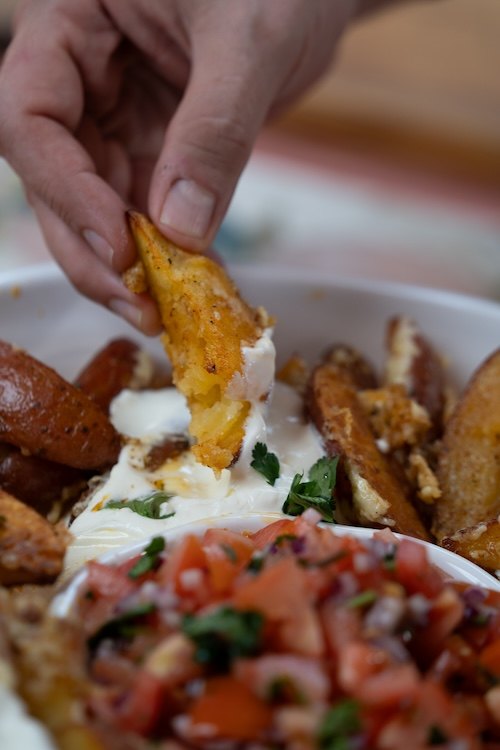 A crispy bite dipped into sauce