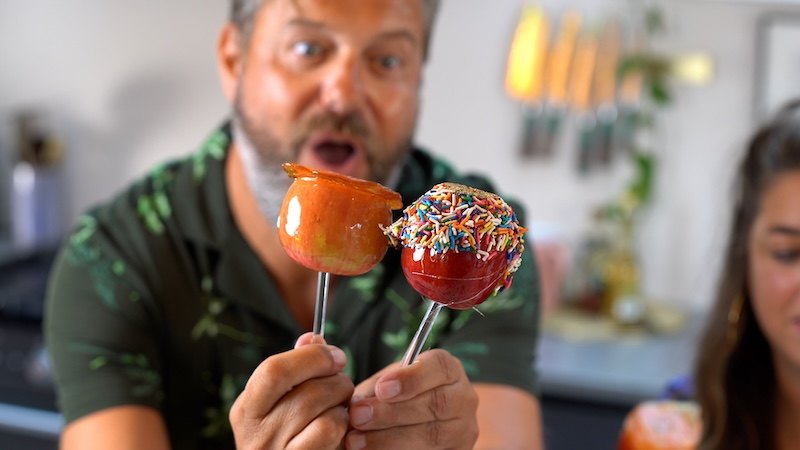 Dom holding colourful toffee apples for the show