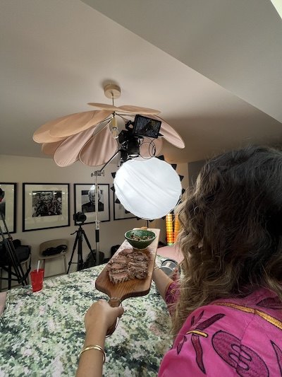 A crew member filming in the kitchen